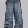 Colossus Jeans XL z podartymi nogawkami i ukrytym wzorem kamuflażu
