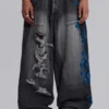 Czarne Colossus Jeans XL z przetarciami i nadrukiem Spike Airbrush