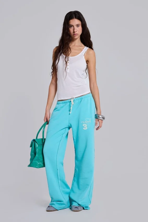 Spodnie dresowe Cleo o luźnym kroju typu bootcut w kolorze turkusowym