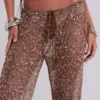 Spodnie z dzianiny z cekinami Deva w kolorze piaskowym