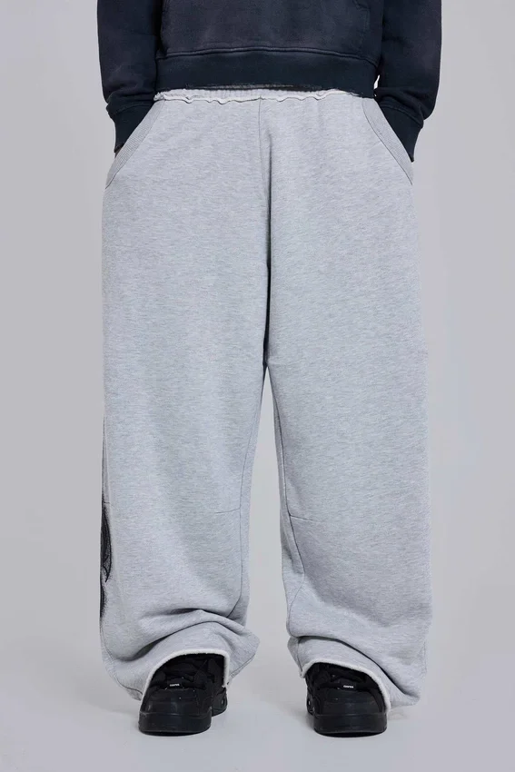 Szare, melanżowe spodnie dresowe typu Monster Joggers z gotyckim nadrukiem „Monster”